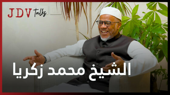 Thoughtful interview with Sheikh Muhammad Zakaria, discussing spirituality and personal growth, captured in a vibrant setting with eye-catching greenery and engaging atmosphere.