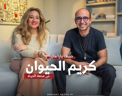 Smiling man and woman sitting on sofa in cozy living room for JDV podcast about animal kindness and pet care tips.