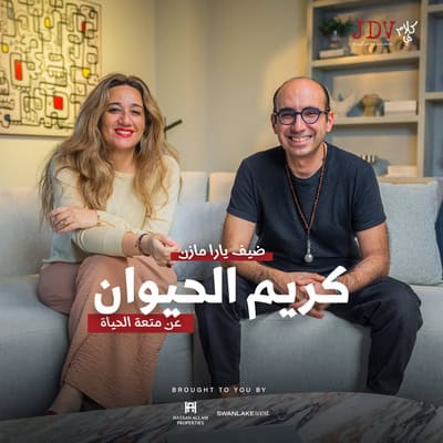 Smiling man and woman sitting on sofa in cozy living room for JDV podcast about animal kindness and pet care tips.