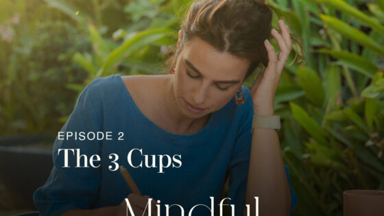 Calm woman practicing mindfulness outdoors with lush green foliage background, emphasizing mental wellness and mindful living for a peaceful lifestyle.