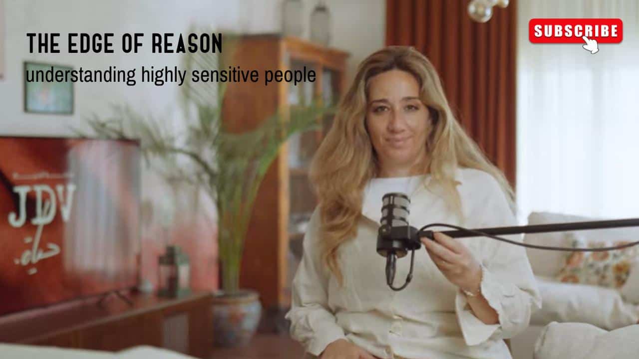 Professional woman with microphone in a home office setting, delivering a podcast or video presentation about understanding highly sensitive people and emotional intelligence.